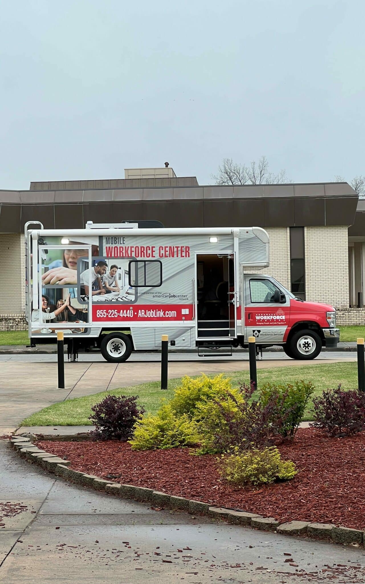 Small mobile workforce center vehicle parked in front of a building